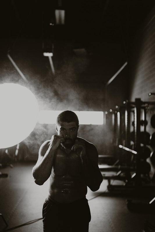 Meka athlete shadow boxing with a light in the background