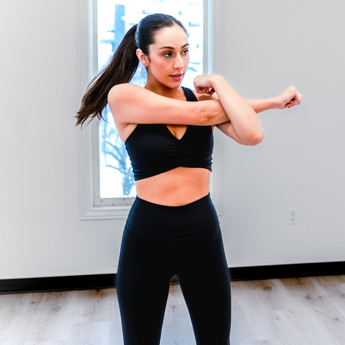 A fit woman stretching before working out